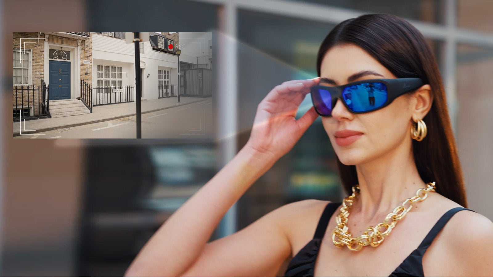 Woman wearing blue mirrored camera glasses with an inset showing street footage recording