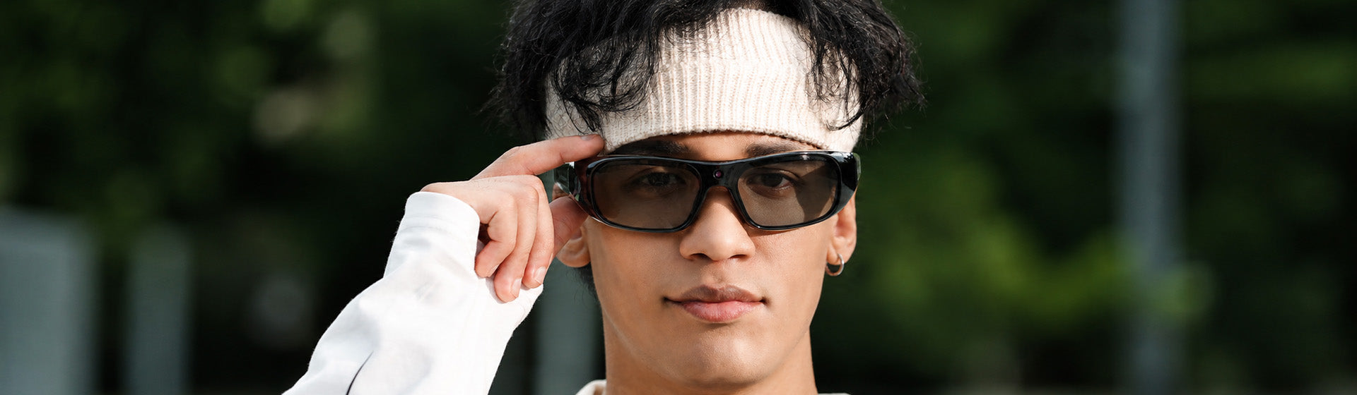 Man in a white headband wearing OhO Sunshine Primex EIS camera sunglasses