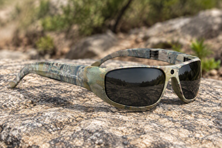 Camouflage camera glasses with a patterned frame and dark lenses.