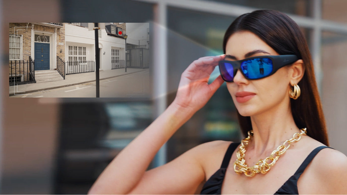 Woman wearing blue mirrored camera glasses with an inset showing street footage recording