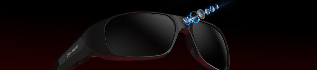 OHO Sunshine camera glasses with black frames and dark tinted lenses, featuring an exploded view of the built-in camera lens against a dark background.