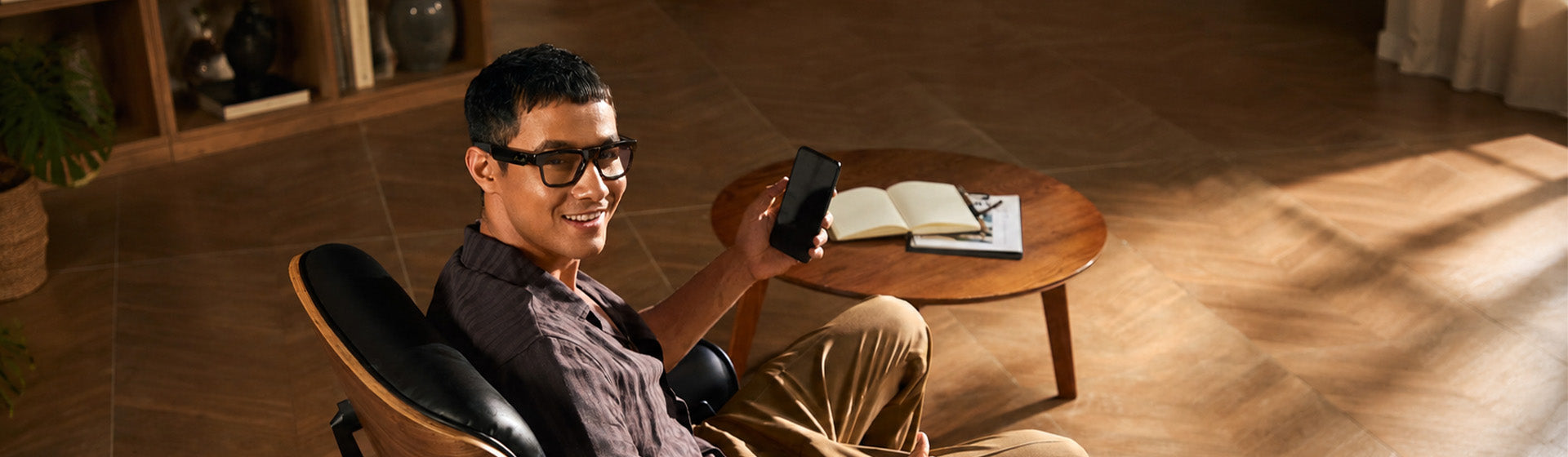 Man relaxing in a lounge chair indoors wearing OhO Sunshine Livi Wi-Fi camera glasses
