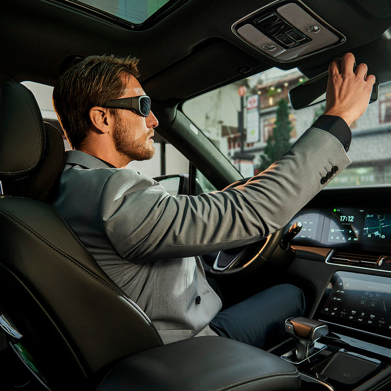 Man wearing OhO Sunshine Pulse Smart Bluetooth Polarized Sunglasses while driving.